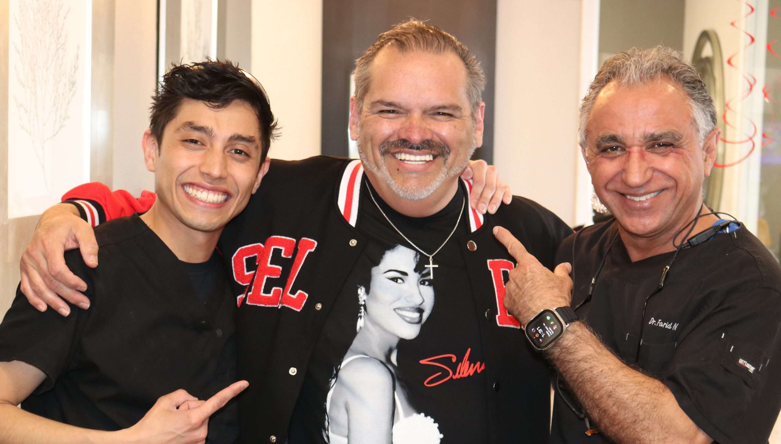 Dr. Farid Noie with a happy patient showcasing a radiant new smile after veneers and dental implants at Unicare Dental in Webster, TX.